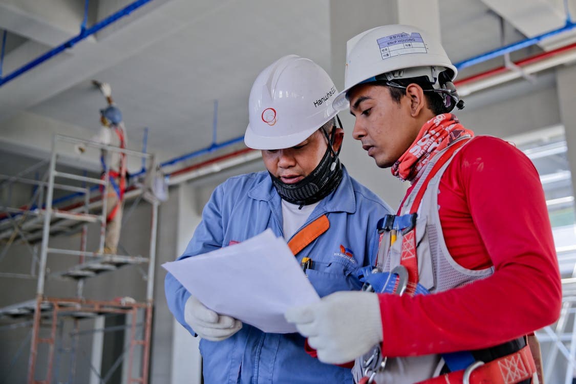 Tradesperson using a laptop on a work site