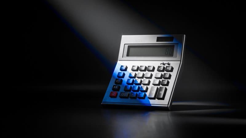 Chrome calculator on black backdrop — web design cost guide for Swindon businesses