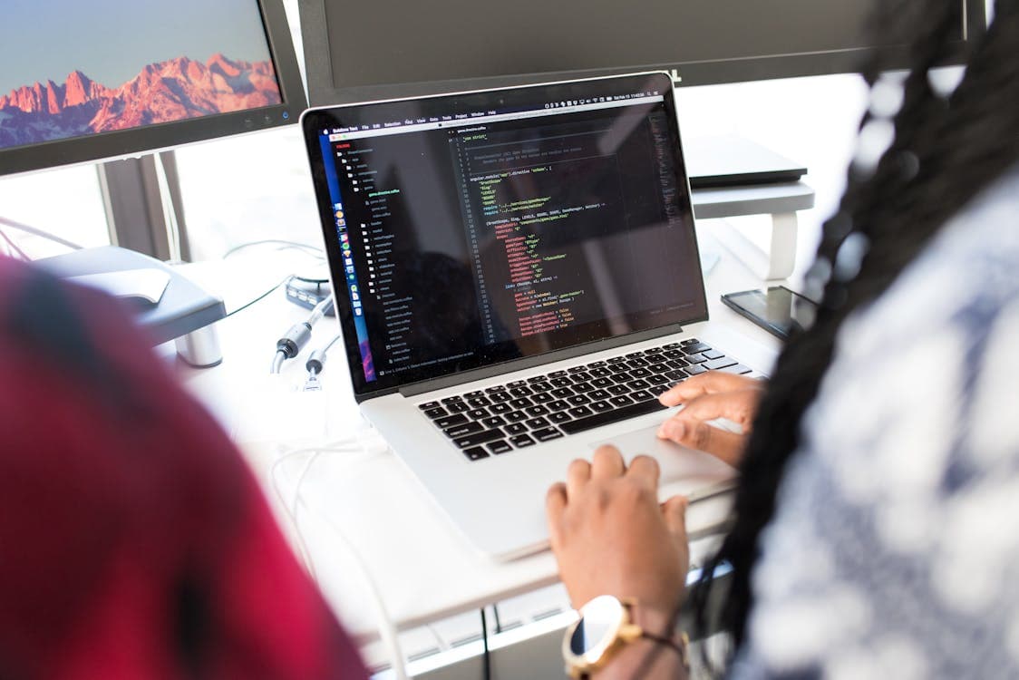 Developer coding a website on a laptop